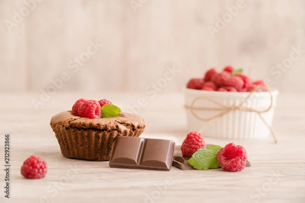 Fototapeta Delicious chocolate lava cake with fresh raspberries, mint and bowl of raspberries