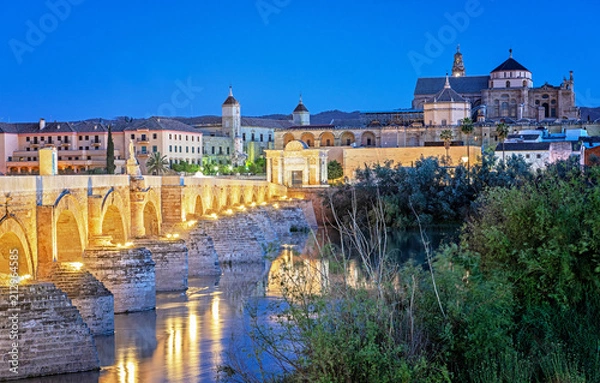 Fototapeta Roman Bridge and Guadalquivir river, Great Mosque, Cordoba, Spain in dusk