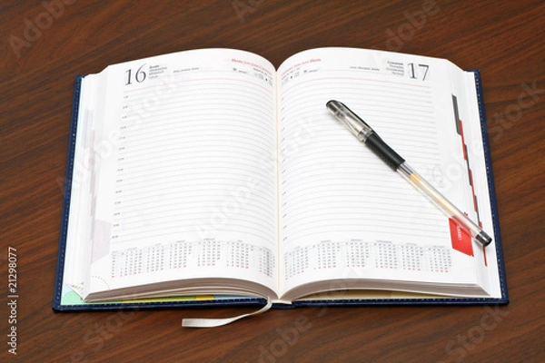 Obraz Diary and a pen on wooden table