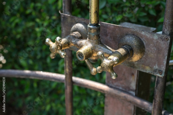 Fototapeta Vintage bronze shower faucet of hot and cold water