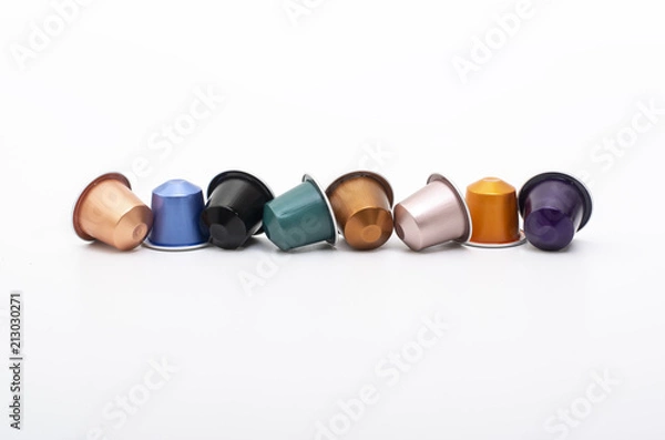 Fototapeta lined up coffee capsules on white background