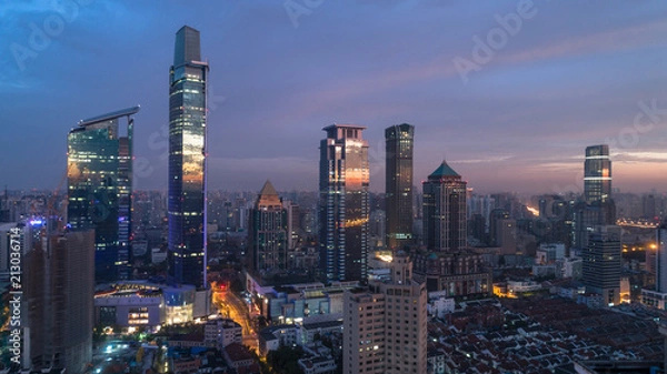 Fototapeta colorful reflection of dawn light on glass of buildings windows, Jingan district, Shanghai, China.