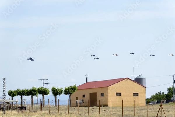 Fototapeta Three Boeing CH-47D Chinook helicopters flying in line with a Eurocopter Super Puma in front of the line