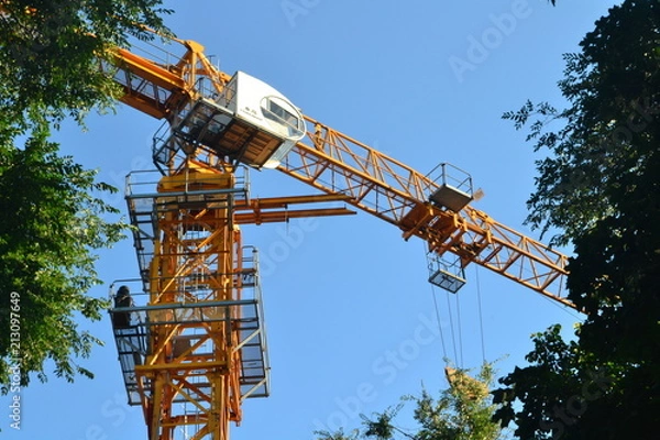 Obraz crane, construction, building, sky, industry, blue, architecture, site, tower, equipment, steel, development, engineering, structure, industrial, yellow, work, tall, high, cranes, machine, heavy