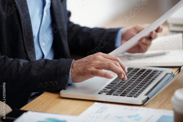 Fototapeta Businessman typing on keyboard