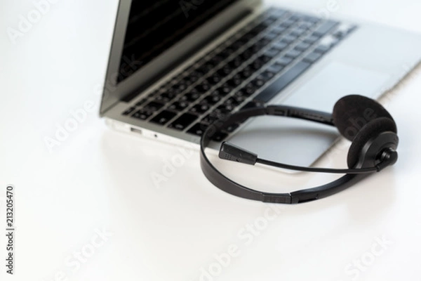 Fototapeta headset and computer laptop, call center support