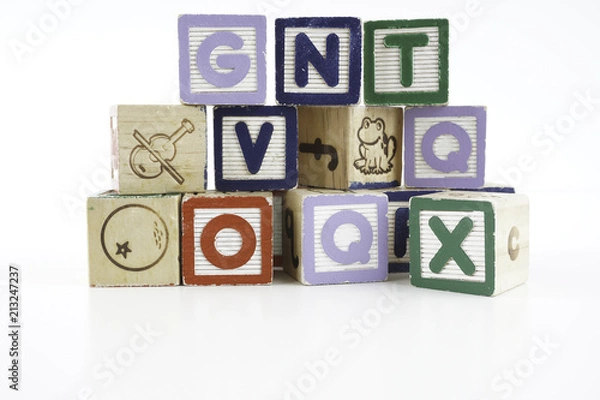 Fototapeta Colored wooden letter blocks on a white background with copy space