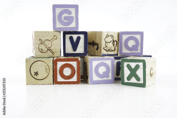 Fototapeta Colored wooden letter blocks on a white background with copy space