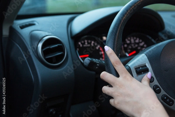 Fototapeta hand on steer wheel adjusting commands
