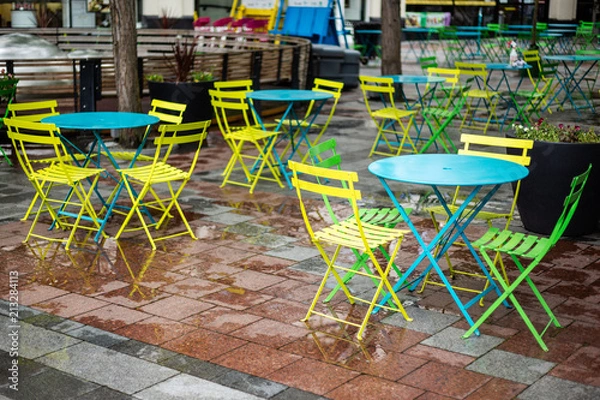 Fototapeta Empty Tables at an outdoor eatery