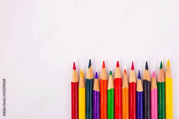 Obraz Assorted colors map coloring pencils framed lower right on solid white background