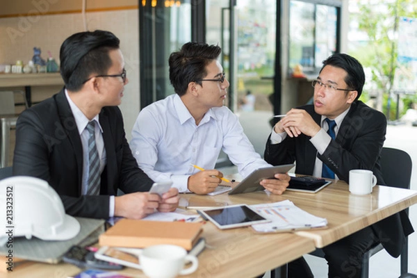 Fototapeta three asian businessman meeting and discussing business in office.