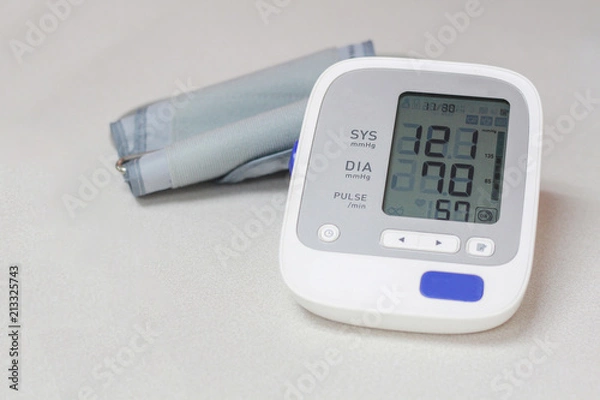 Fototapeta Autonamic blood pressure  showing a normal blood pressure on white background.spot focus.
