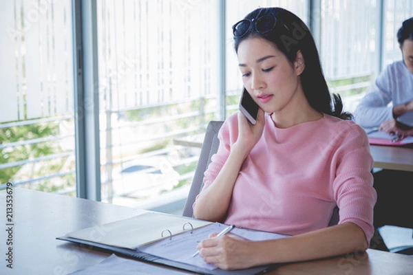 Obraz Business concept, Business woman working with bill and phone on wooden table.