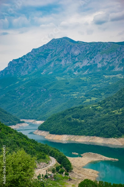 Obraz An unusual mountain lake with turquoise water is located in a canyon among the high mountains.