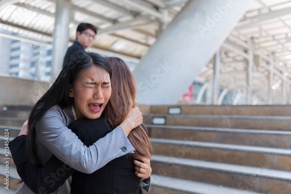 Obraz A picture of a beautiful businesswoman comforting a workmate