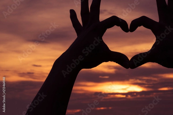 Fototapeta Hands as heart shape with beautiful sky in twilight background,love and romantic concept.