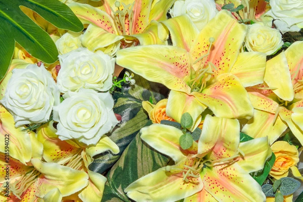 Fototapeta Close up group of white and yellow flowers and leaves in colorful tone.