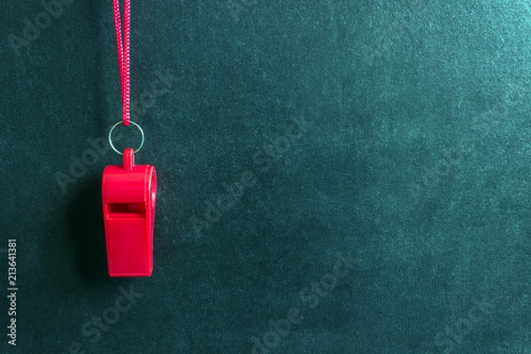 Fototapeta Sports whistle on a red lace.Concept- sport competition, referee, statistics, challenge, friendly match.Copy space.