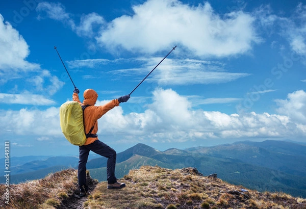 Fototapeta Hiker enjoying the trip in the top of mountain.