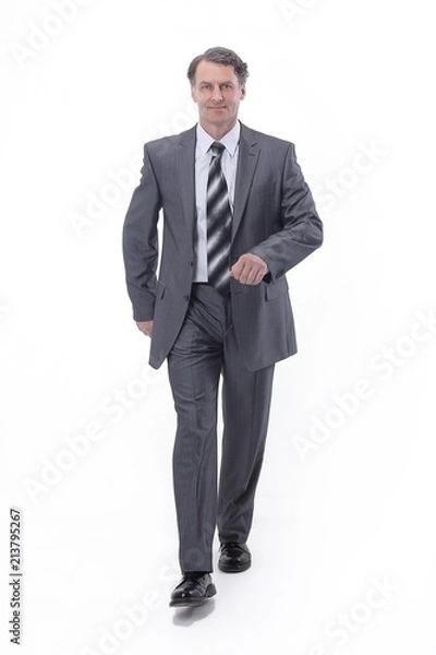 Fototapeta in all growth.a successful businessman, confidently striding forward.