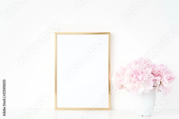 Fototapeta Gold portrait a4 frame mockup template with peonies in vase on white background. Empty frame mock up for presentation design, modern art.