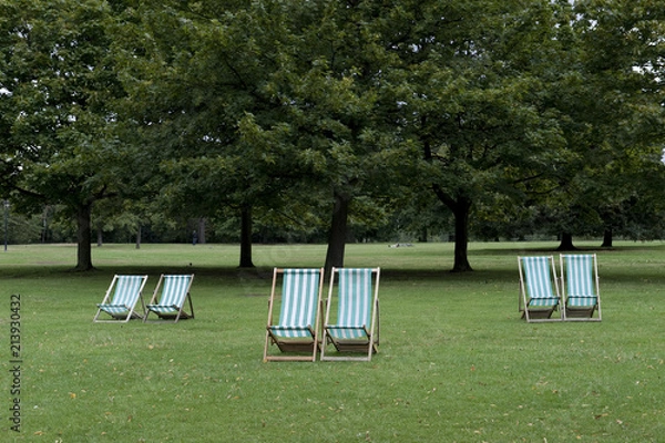 Fototapeta Empty deck chairs in the park