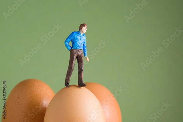 Obraz Walking on Eggshells - model figure on top of eggs