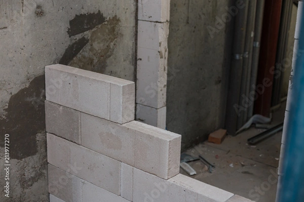 Obraz Mason plastering the concrete to build wall, Construction under building with mason plastering concrete to brick wall
