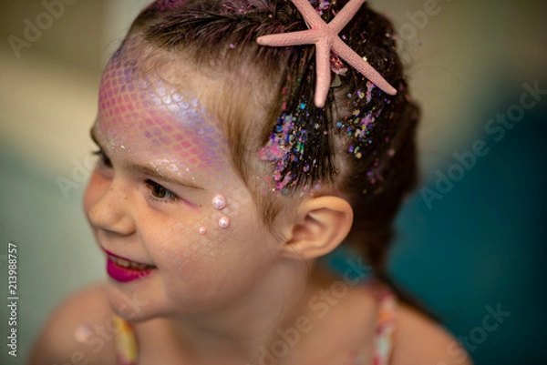Obraz Portrait of a beautiful young mermaid girl at salon getting makeup on