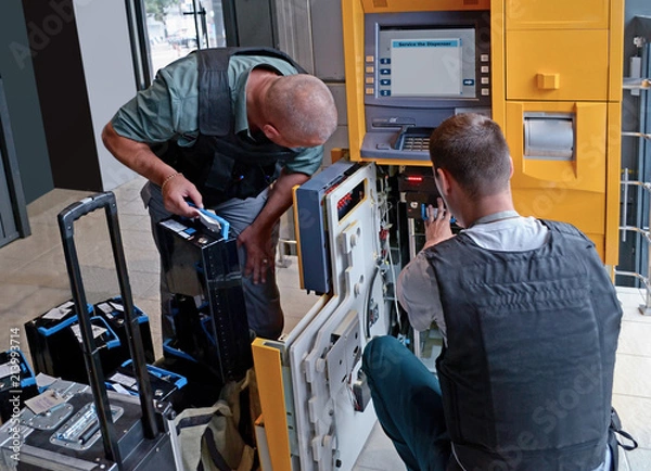 Fototapeta Security Service is doing service for ATM. ATM loading with money
