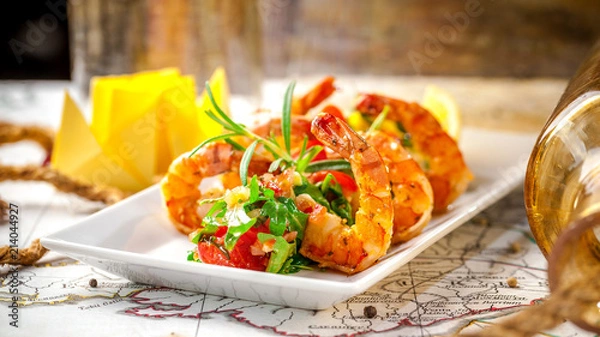 Obraz Balkan cuisine. Sea prawns with Mexican salsa on the background of geographical maps, rope and empty bottles. concept sea voyage. Copy space, selective focus