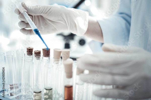 Fototapeta For the analysis. Close up of a test sample being taken from a test tube for professional biological analysis