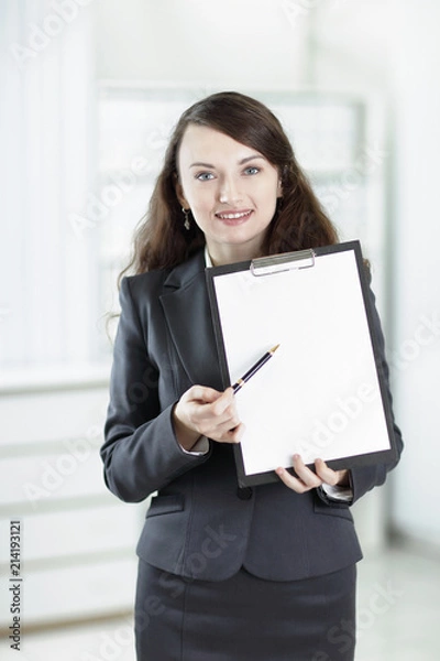 Obraz modern business woman pointing at blank sheet.