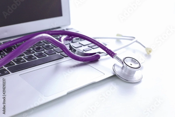 Fototapeta Stethoscope lying on a laptop keyboard in a concept of online m
