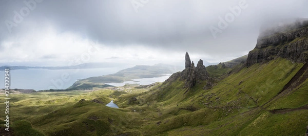 Fototapeta A path to the Old Man of Storr on the Isle of Skye with a sea in the background during a cloudy summer day in Scotland