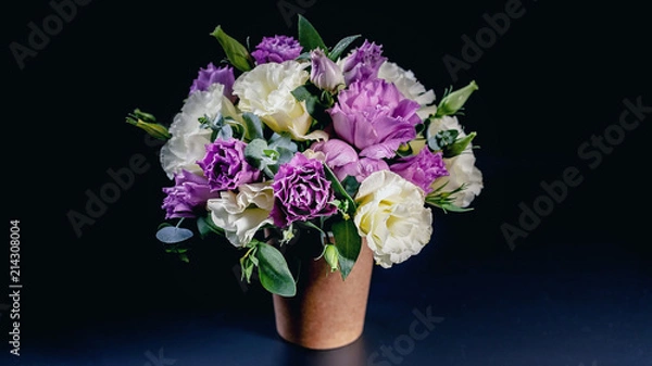 Obraz Bouquet of flowers in a coffee cup on a dark blue background. Flower compliment