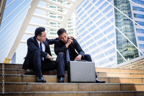 Fototapeta Two asian Businessman feel sad and frustrated upset fail in life.