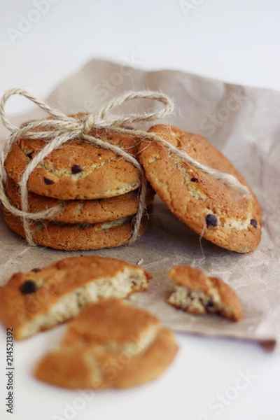 Fototapeta cookies with chocolate. oat cookies with bow on craft paper and light background