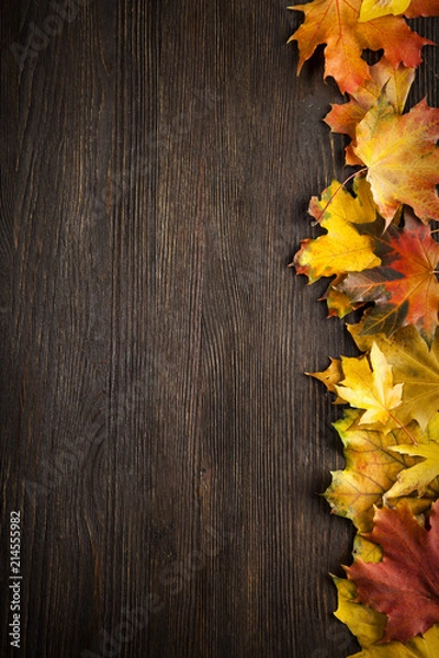 Fototapeta autumn leaf on wood background (top view) orange leaf on old grunge wood deck, copy place for inscription, tablet for text