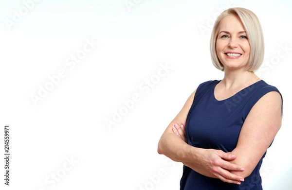 Obraz Attractive middle aged woman with folded arms on white background