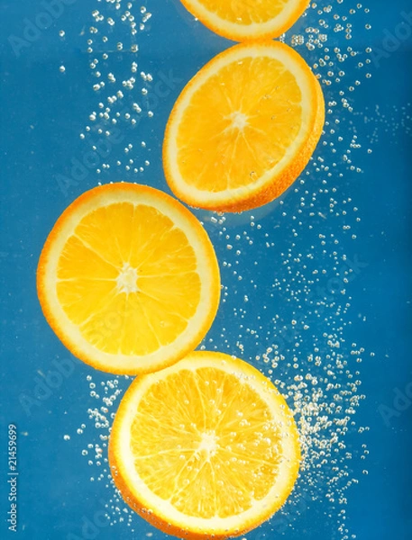 Obraz Fresh orange dropped into water with bubbles
