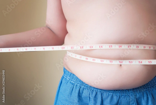 Fototapeta Fat boy with overweight checking out his weight isolated on white background