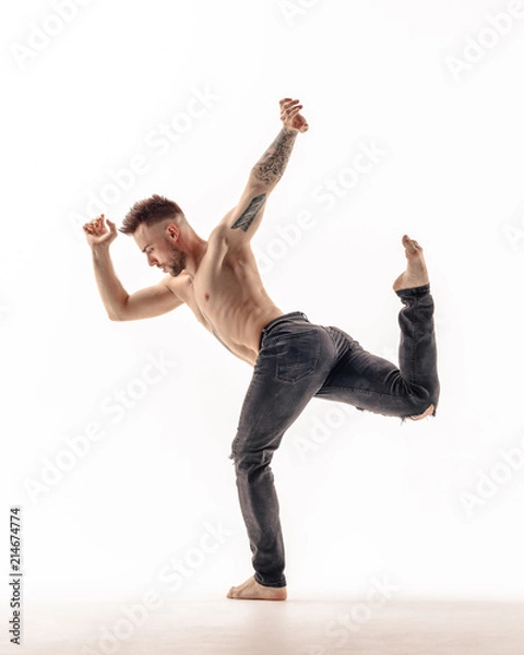Fototapeta Young beautiful dancer is posing in studio