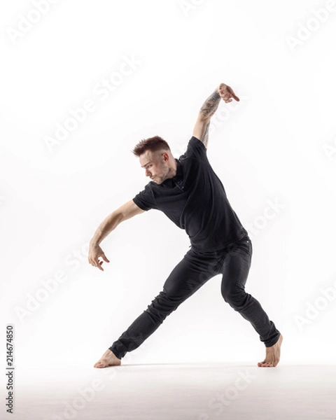Fototapeta Young beautiful dancer is posing in studio