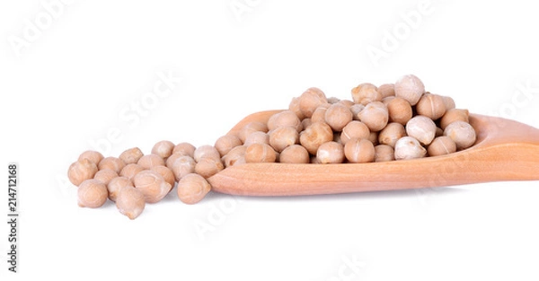 Fototapeta Close-up uncooked chickpeas in wooden spoon on white background.