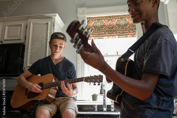 Fototapeta Two Teeenage Boys Jamming with Guitars after school