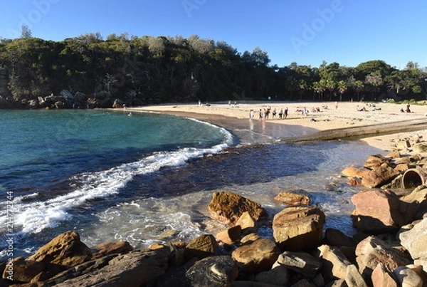 Fototapeta Shelly Beach and Cabbage Tree Bay Aquatic Reserve at Manly with sand and Tasman Sea. People relaxing on sandy Shelly beach at Manly.
