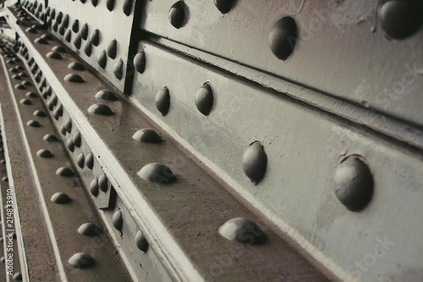 Obraz The metallic part is painted black. Huge screws firmly hold the massive parts of the bridge.