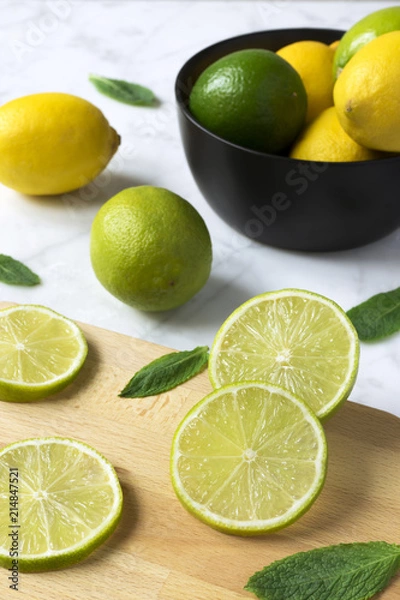 Obraz lemons and limes on a cutting board